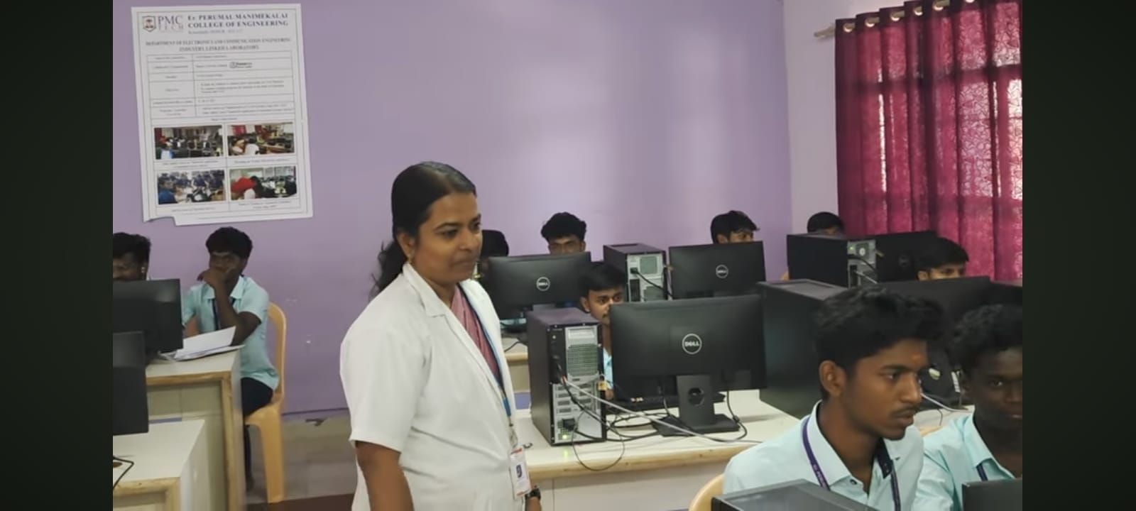 Artificial Intelligence & Machine Learning Laboratory: students at desktop computers, with a person in a white coat standing among the benches.