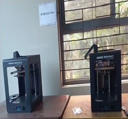 Two 3D printers on a bench in the centre of excellence