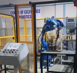 A robotic welding arm inside the fenced cell of the Centre of Excellence in Robotics