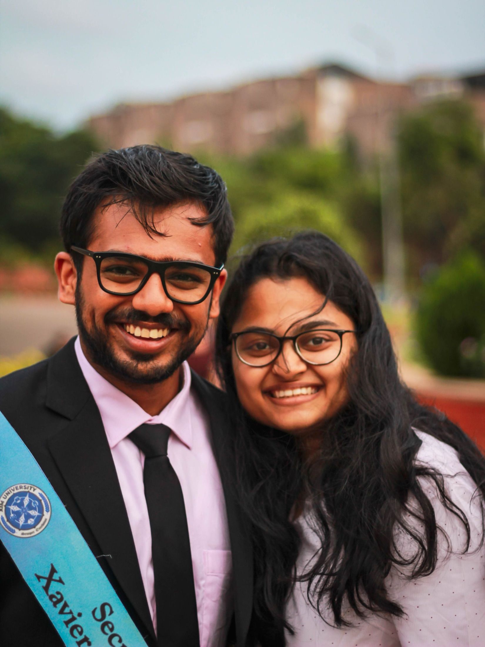 Two graduates smiling together on graduation day