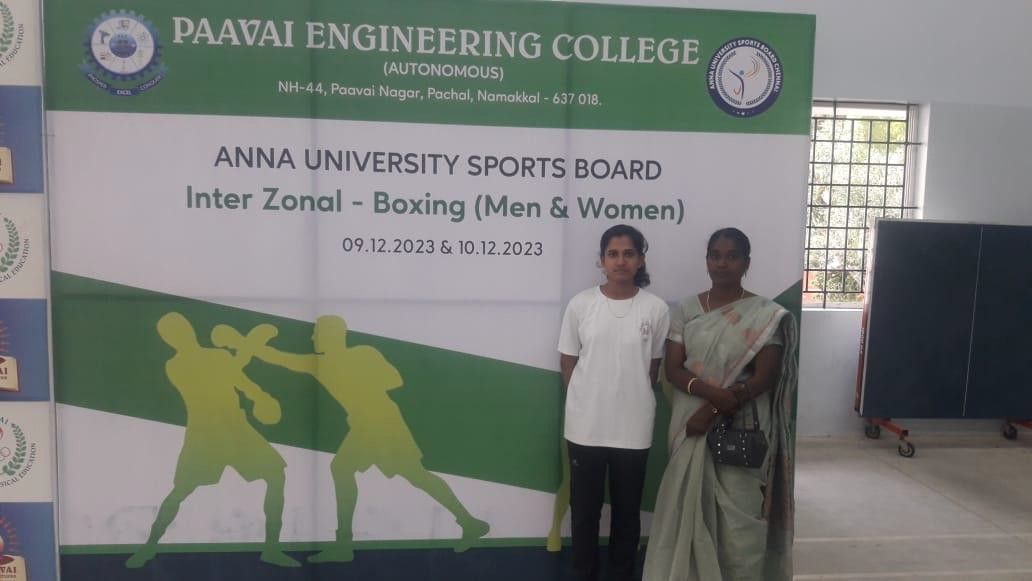 Two women standing beside a banner reading “Anna University Sports Board, Inter Zonal – Boxing (Men & Women), 09.12.2023 & 10.12.2023”, under the name of Paavai Engineering College