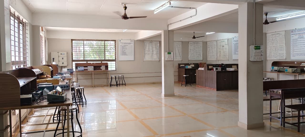 A tiled hall with wooden benches carrying trainer kits, stools, pillars and notice boards on the back wall.